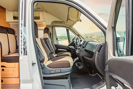 A mechanic performing routine maintenance on RV tires, emphasizing tire care.