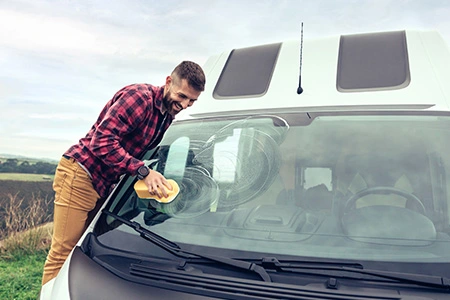 An RV parked with a focus on its tires, illustrating the importance of RV tire insurance.